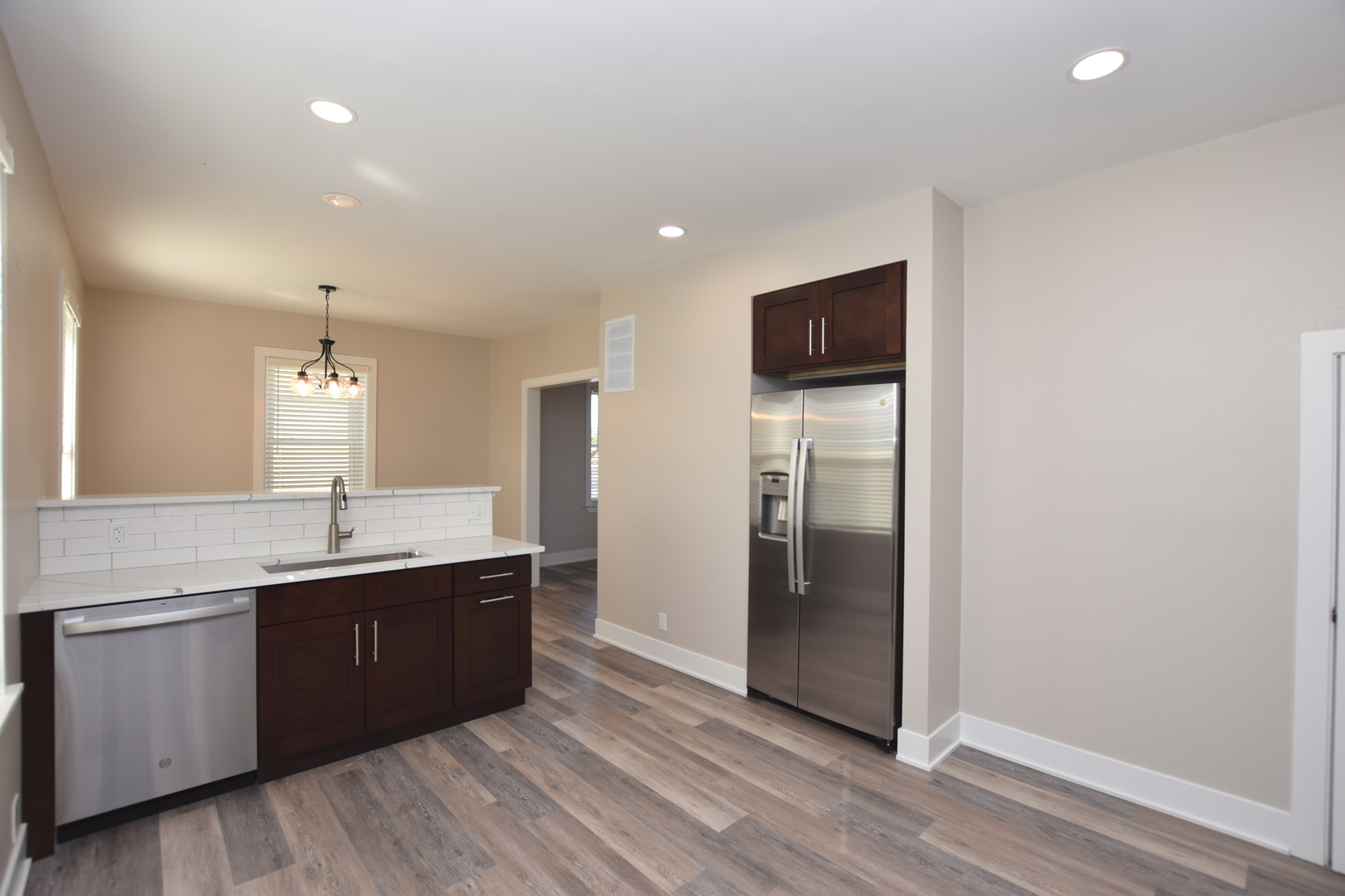 97 Gates Street Crystal Lake, IL 60014 - Photo 3 of 22 a kitchen with stainless steel appliances granite countertop a sink and cabinets