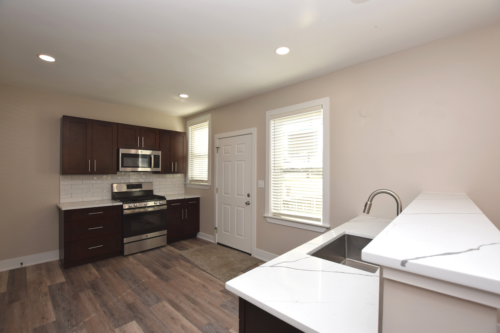 97 Gates Street Crystal Lake, IL 60014 - Photo 4 of 22 a kitchen with sink refrigerator and stove