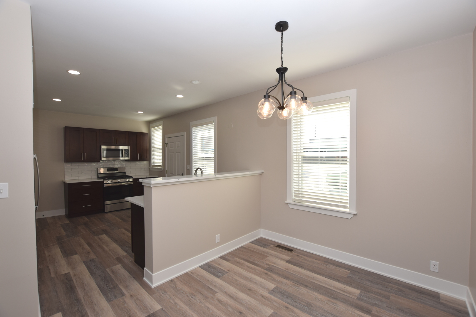 97 Gates Street Crystal Lake, IL 60014 - Photo 6 of 22 a kitchen with stove cabinets and wooden floor