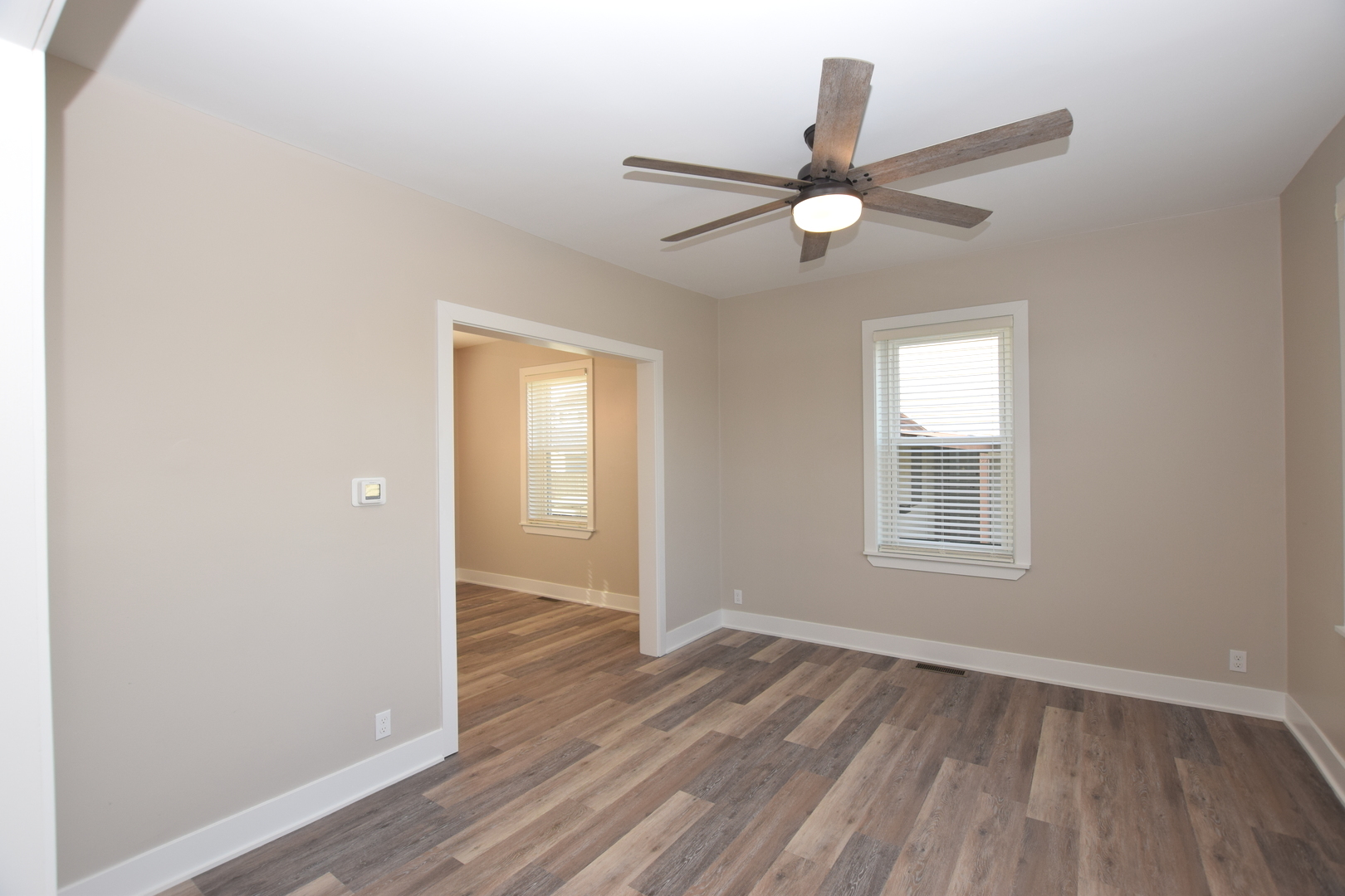 97 Gates Street Crystal Lake, IL 60014 - Photo 8 of 22 an empty room with wooden floor fan and windows