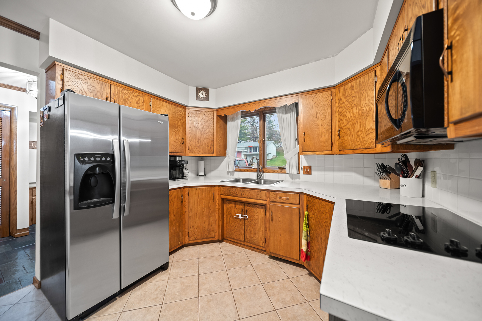 3138 12th Avenue Moline, IL 61265 - Photo 11 of 34 a kitchen with stainless steel appliances granite countertop a sink a stove and a refrigerator