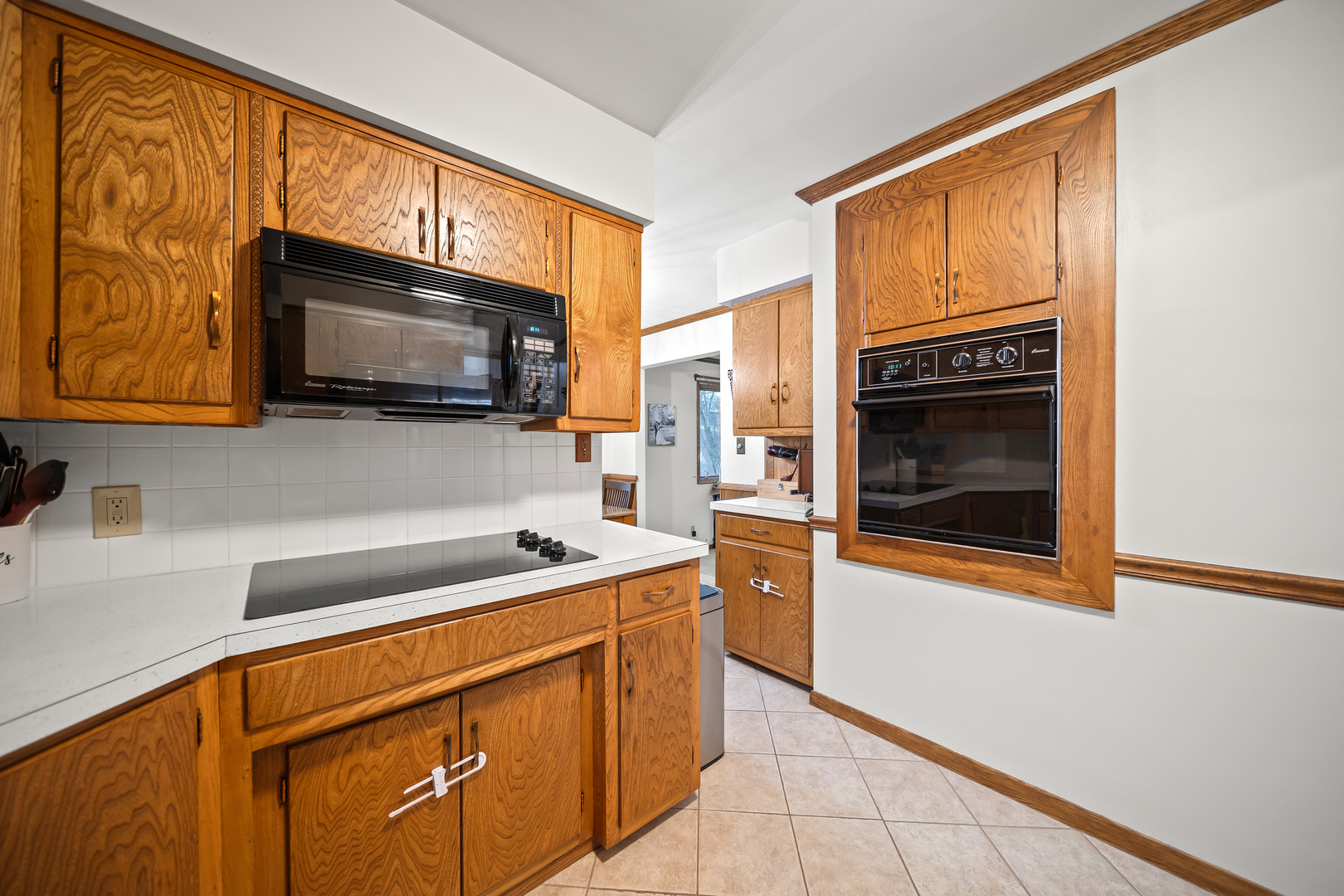 3138 12th Avenue Moline, IL 61265 - Photo 12 of 34 a kitchen with stainless steel appliances a stove microwave and sink
