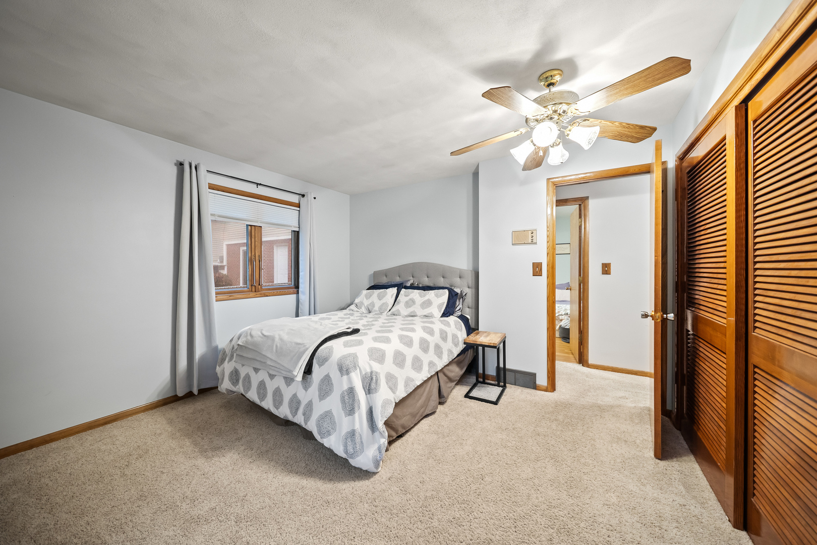 3138 12th Avenue Moline, IL 61265 - Photo 18 of 34 a bedroom with a bed and a chandelier