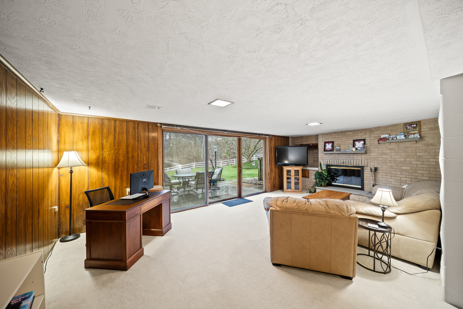 3138 12th Avenue Moline, IL 61265 - Photo 22 of 34 a living room with furniture a fireplace and a flat screen tv