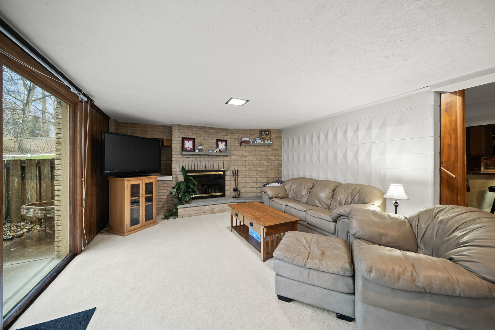 3138 12th Avenue Moline, IL 61265 - Photo 23 of 34 a living room with furniture a flat screen tv and a fireplace