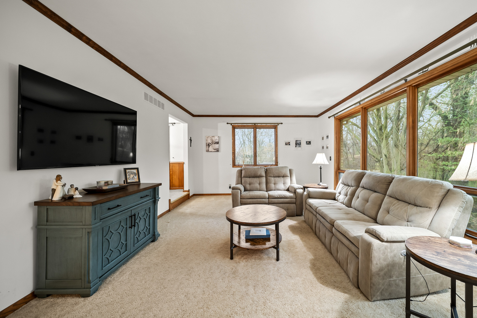 3138 12th Avenue Moline, IL 61265 - Photo 7 of 34 a living room with furniture a flat screen tv and a large window