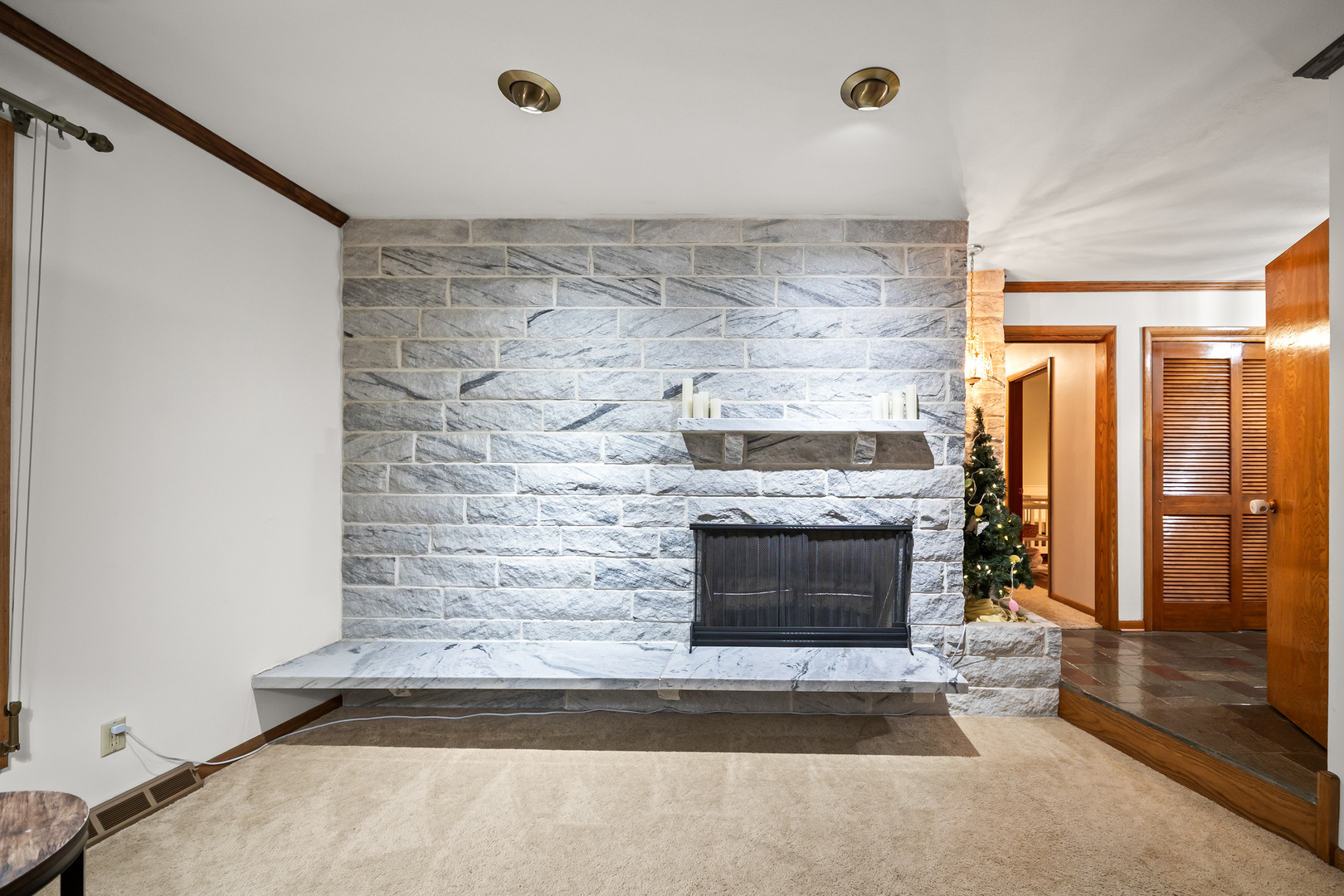 3138 12th Avenue Moline, IL 61265 - Photo 8 of 34 a living room with a fireplace and a rug