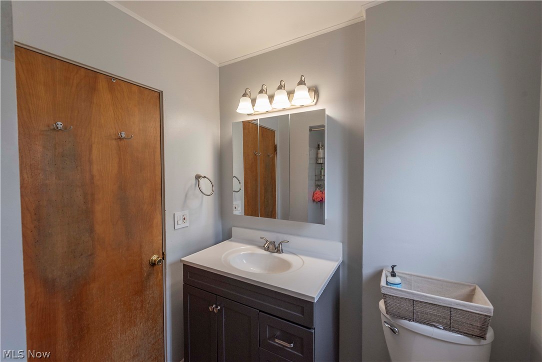 400 Baldwin Road Akron, OH 44312 - Photo 18 of 43 Main floor full bathroom vanity featuring a white countertop with an integrated sink and a dark wood-finish cabinet