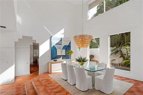 a living room with a couch and a potted plant