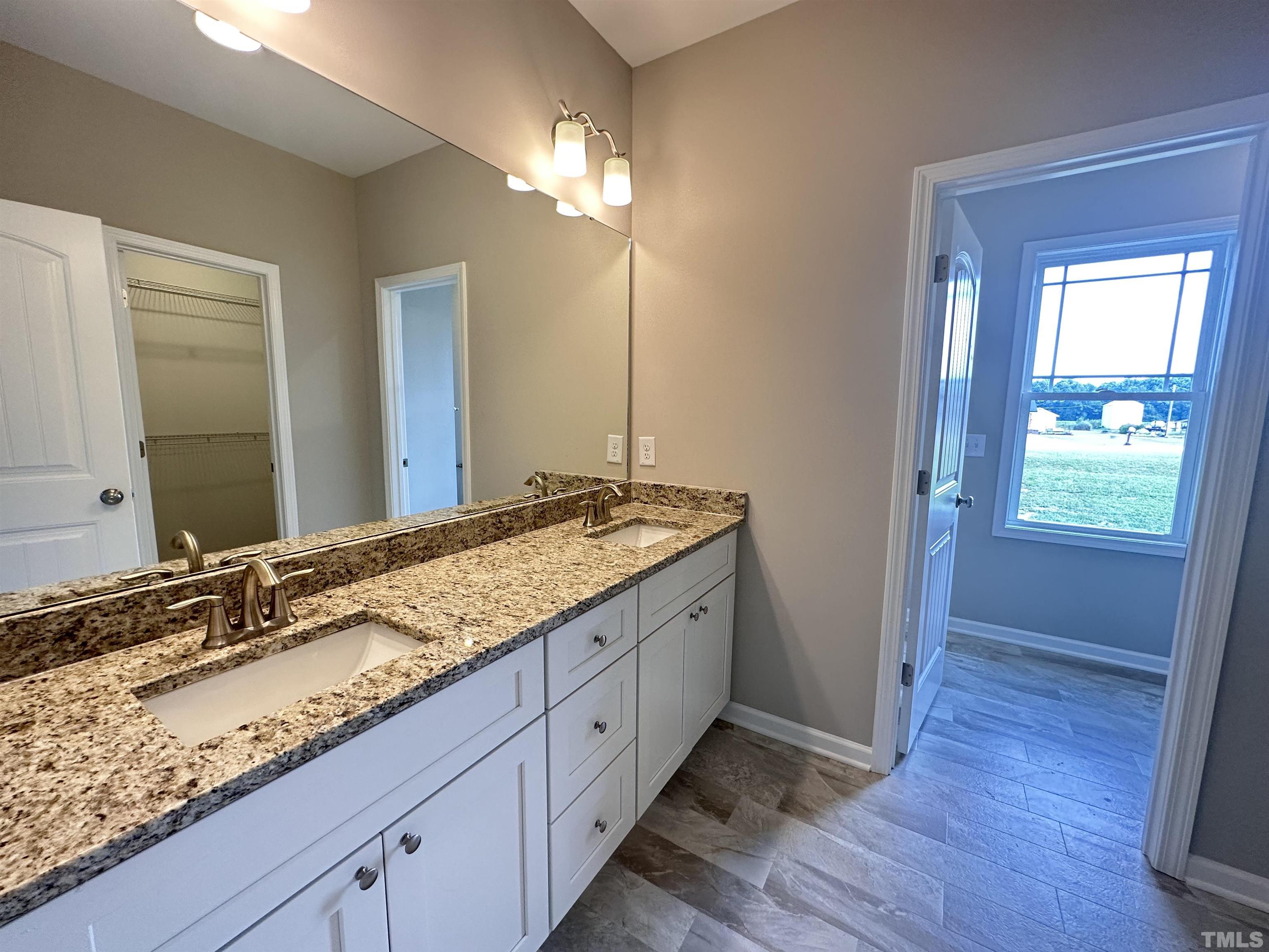 7519 Springfield School Road Lucama, NC 27851 - Photo 5 of 8 a bathroom with a granite countertop sink and a mirror