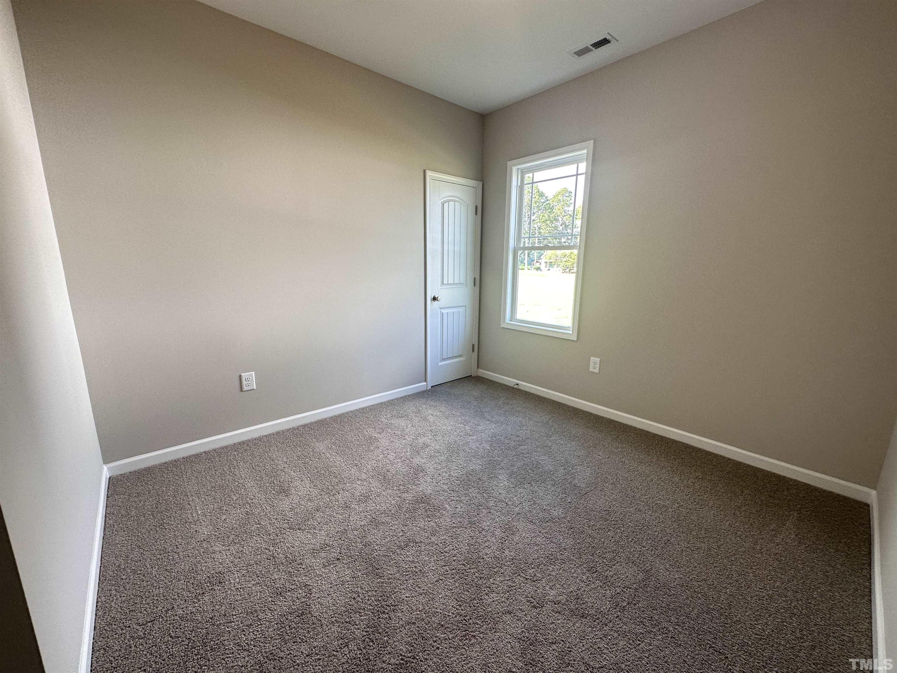 7519 Springfield School Road Lucama, NC 27851 - Photo 8 of 8 an empty room with a window