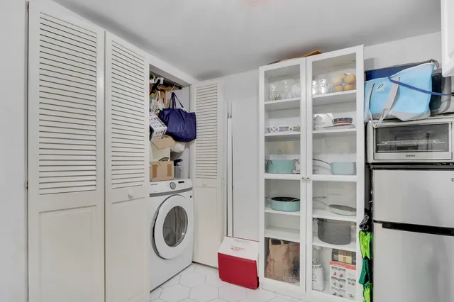 a utility room with closet dryer and washer