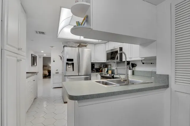 a kitchen with stainless steel appliances granite countertop a sink and cabinets