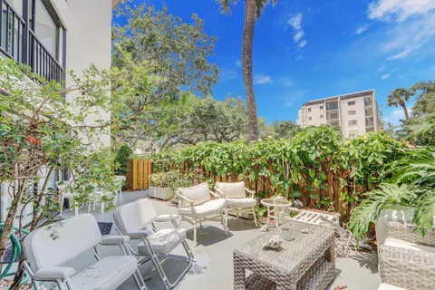 a view of a patio with table and chairs and potted plants