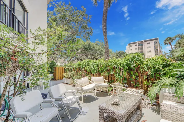 a view of a patio with table and chairs and potted plants