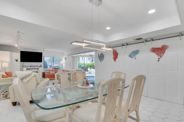 a dining room with furniture and a flat screen tv
