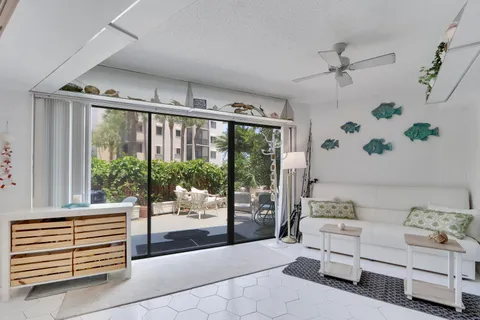 a living room with furniture and large windows