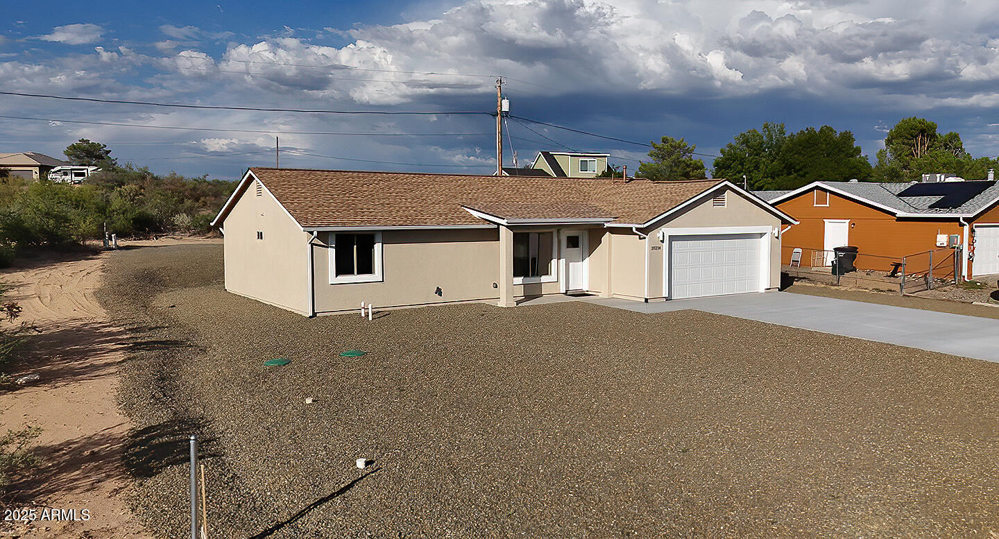 20214 East Mesa Verde Road Mayer, AZ 86333 - Photo 23 of 26 a front view of a house with a yard and garage