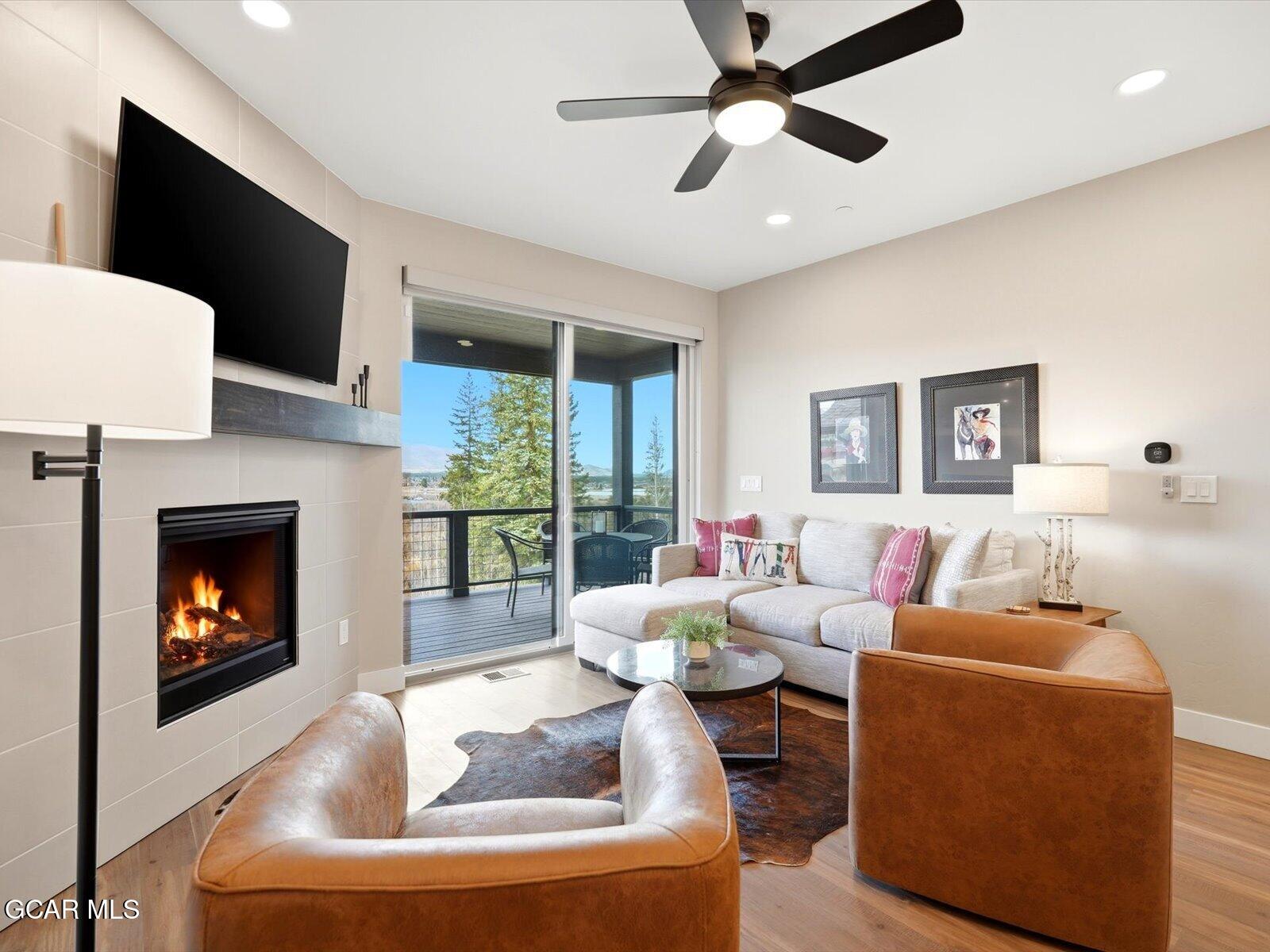 95 River Run Circle Fraser, CO 80442 - Photo 31 of 66 a living room with furniture a flat screen tv and a fireplace