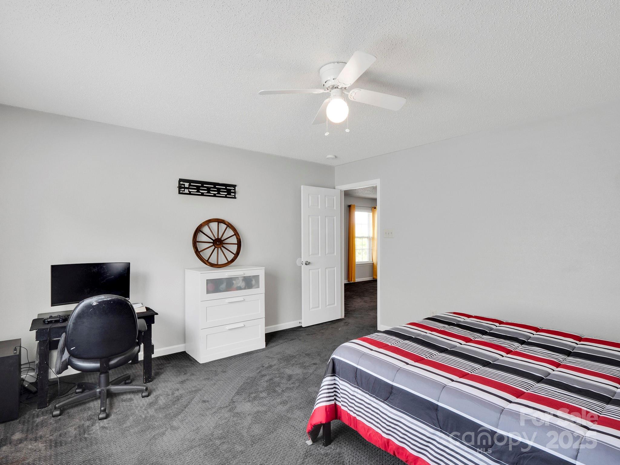 4148 Shasta Circle Clover, SC 29710 - Photo 24 of 48 a bedroom with a bed and a chandelier