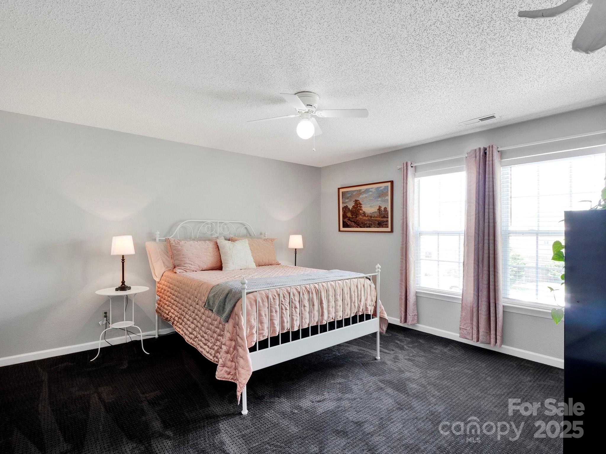 4148 Shasta Circle Clover, SC 29710 - Photo 25 of 48 a bedroom with a large bed chandelier and a window
