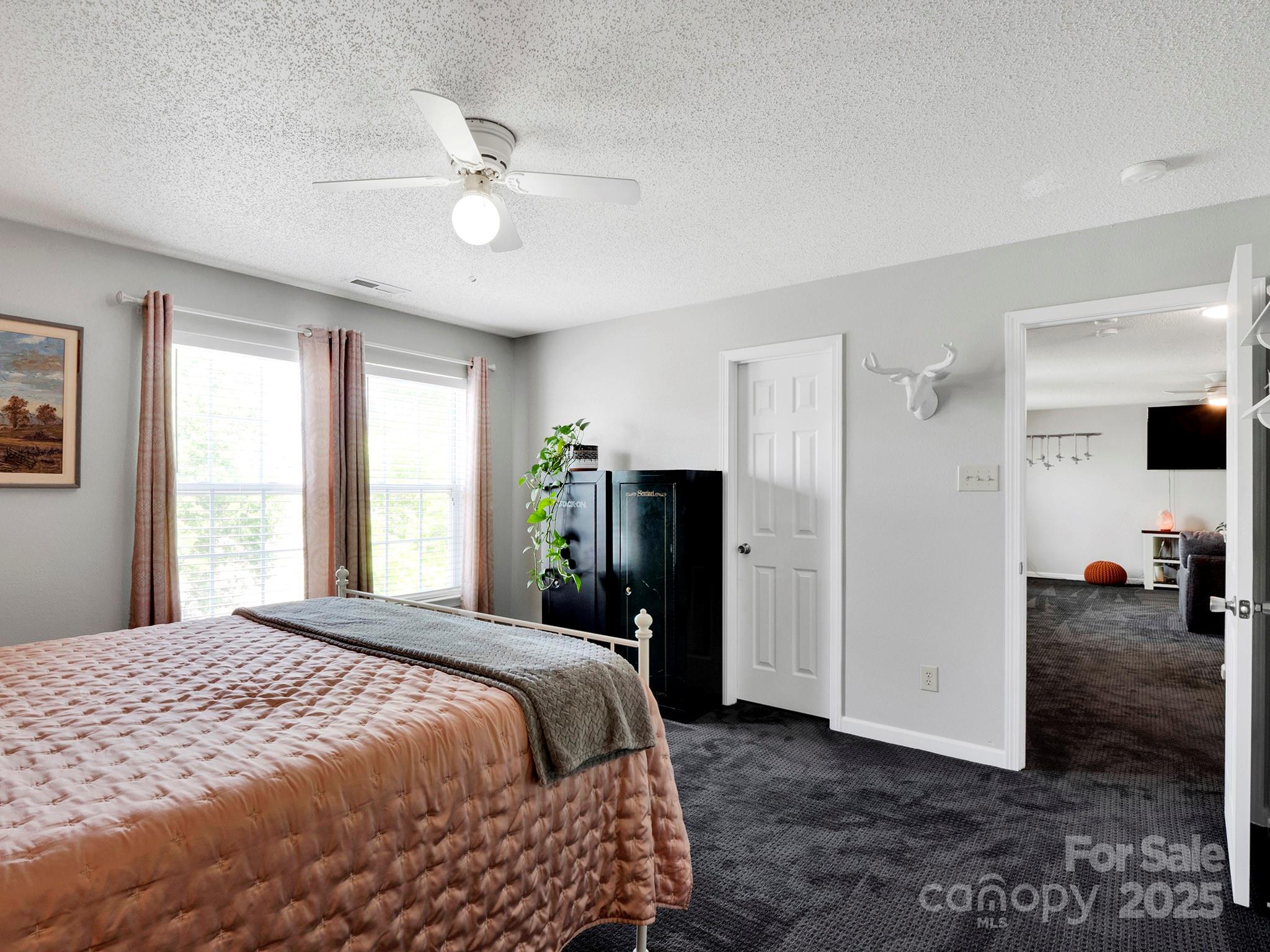 4148 Shasta Circle Clover, SC 29710 - Photo 26 of 48 a bedroom with a bed and a chandelier