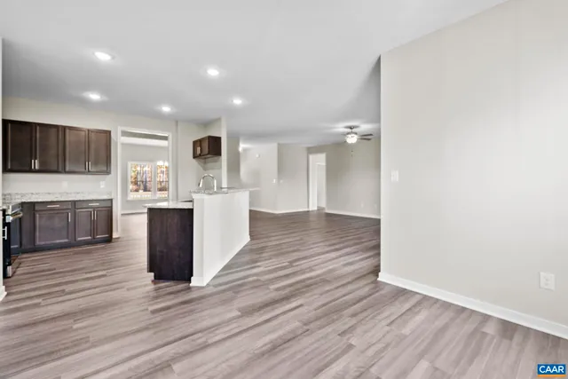 a kitchen with stainless steel appliances kitchen island granite countertop a stove a sink and a microwave