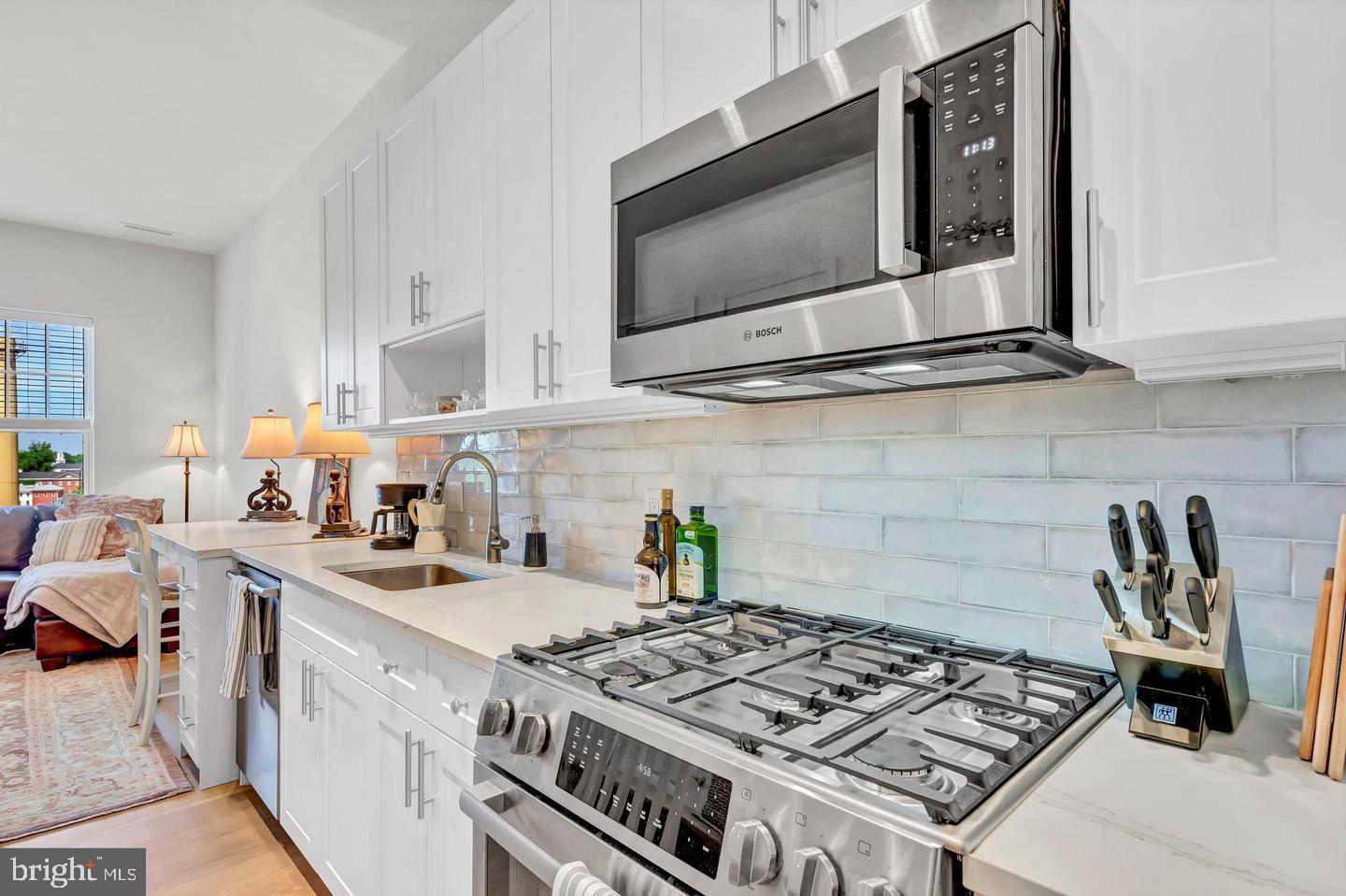 6803 Cameron Drive Northwest, Unit 514 Washington, DC 20012 - Photo 13 of 50 a kitchen with a stove and a microwave