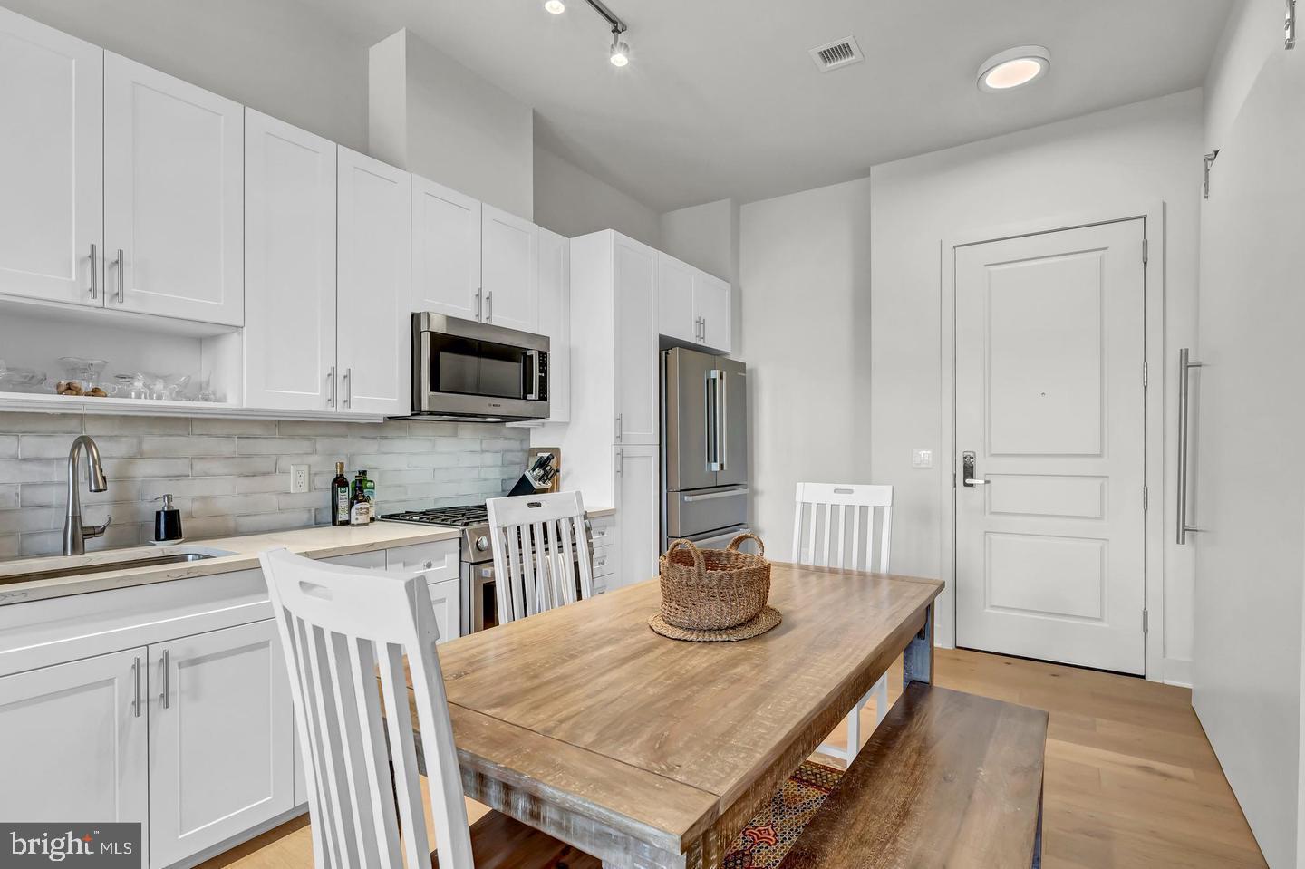 6803 Cameron Drive Northwest, Unit 514 Washington, DC 20012 - Photo 18 of 50 a kitchen with granite countertop a sink stove and refrigerator