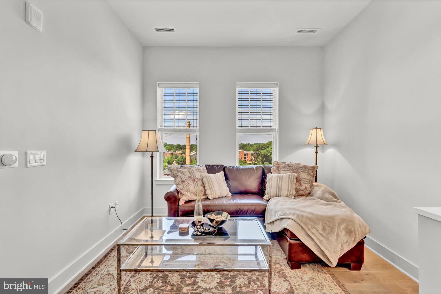 6803 Cameron Drive Northwest, Unit 514 Washington, DC 20012 - Photo 21 of 50 a living room with furniture and wooden floor