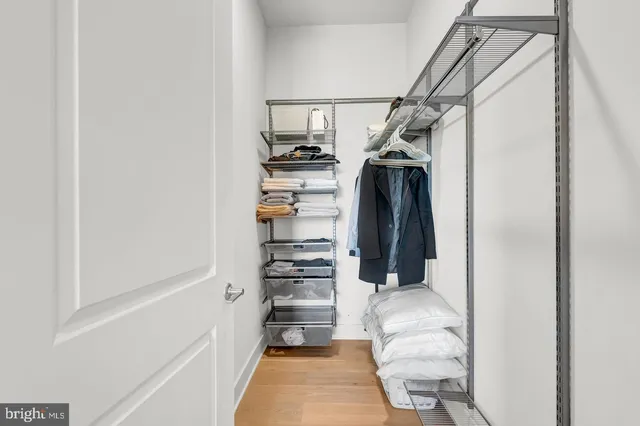 a bedroom with a bed and a large mirror