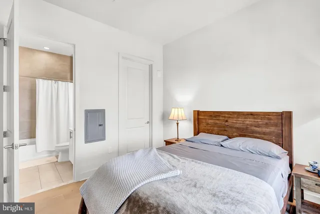 a bedroom with a bed and a night stand