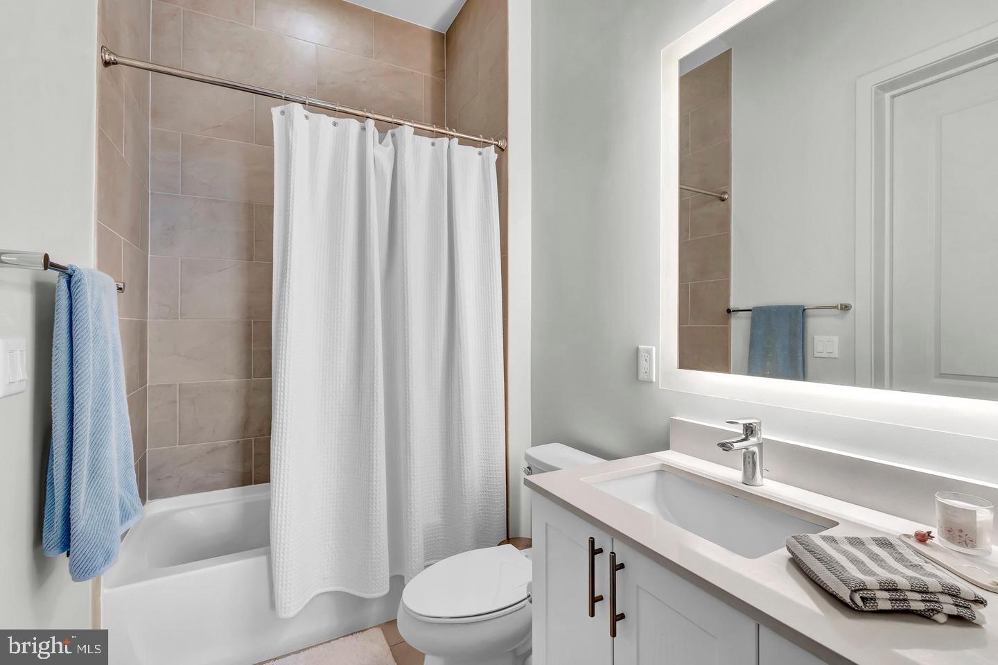 6803 Cameron Drive Northwest, Unit 514 Washington, DC 20012 - Photo 26 of 50 a bathroom with a sink a toilet and shower