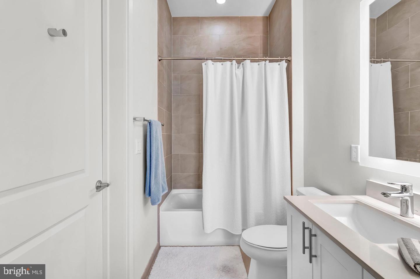 6803 Cameron Drive Northwest, Unit 514 Washington, DC 20012 - Photo 27 of 50 a bathroom with a sink a toilet and a mirror