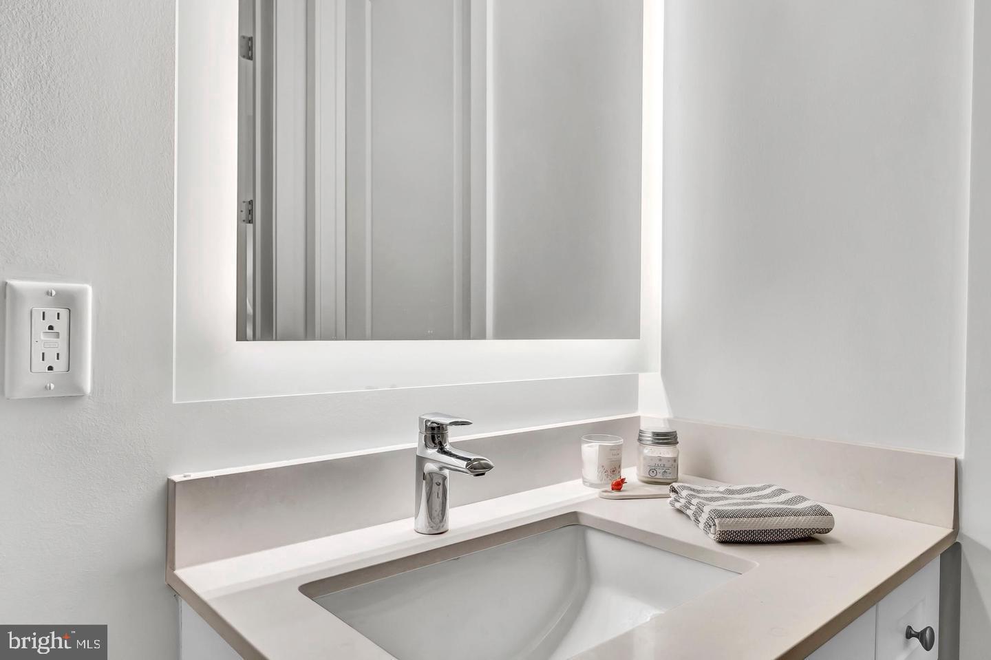 6803 Cameron Drive Northwest, Unit 514 Washington, DC 20012 - Photo 30 of 50 a bathroom with a sink and a mirror