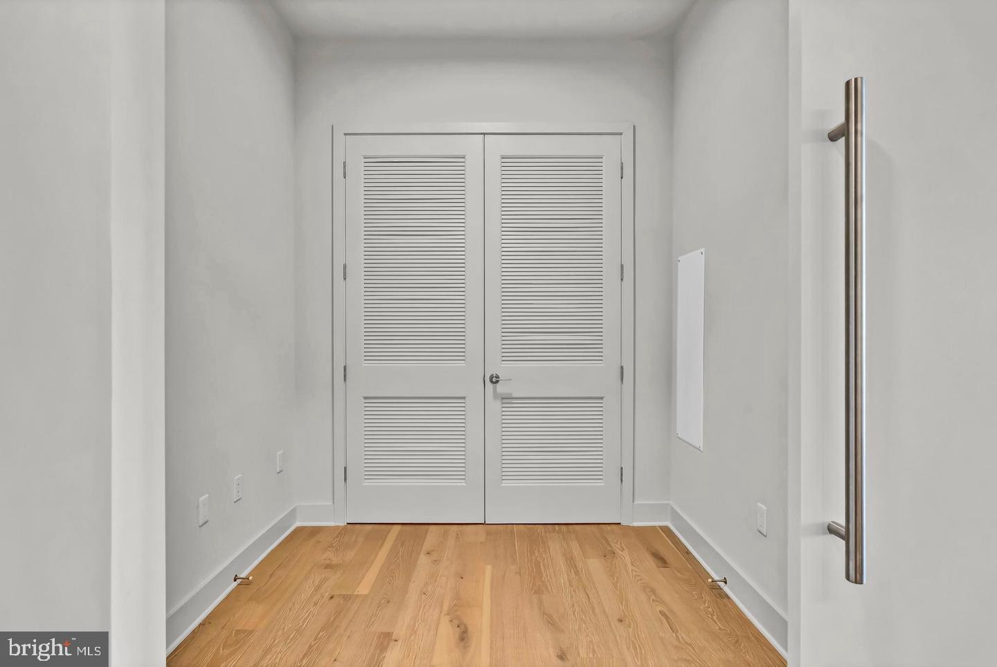 6803 Cameron Drive Northwest, Unit 514 Washington, DC 20012 - Photo 33 of 50 wooden floor in an empty room