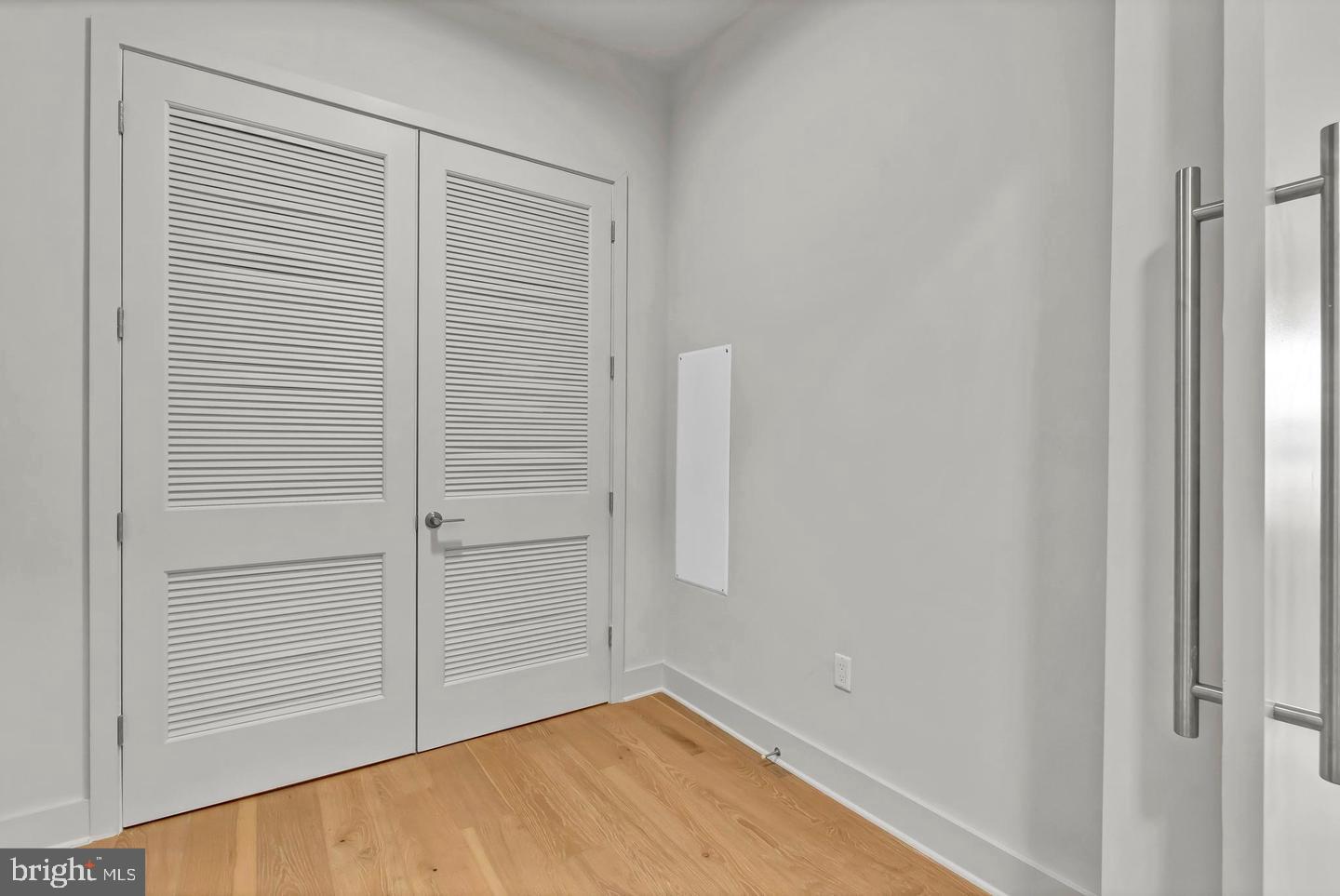 6803 Cameron Drive Northwest, Unit 514 Washington, DC 20012 - Photo 34 of 50 an empty room with a wooden floor