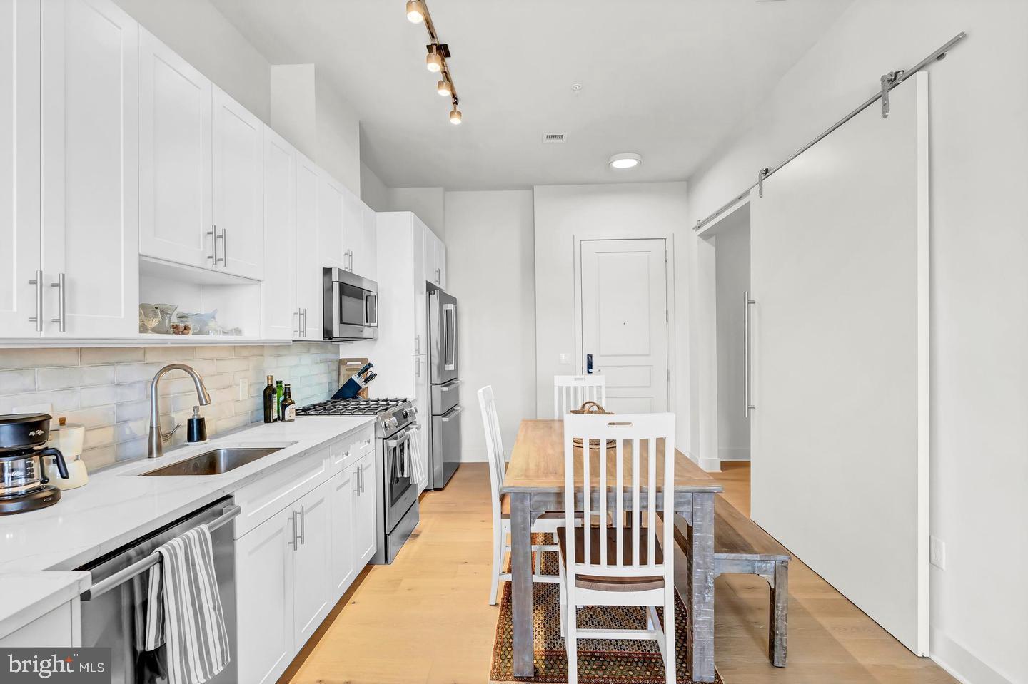 6803 Cameron Drive Northwest, Unit 514 Washington, DC 20012 - Photo 35 of 50 a kitchen with sink cabinets and stove