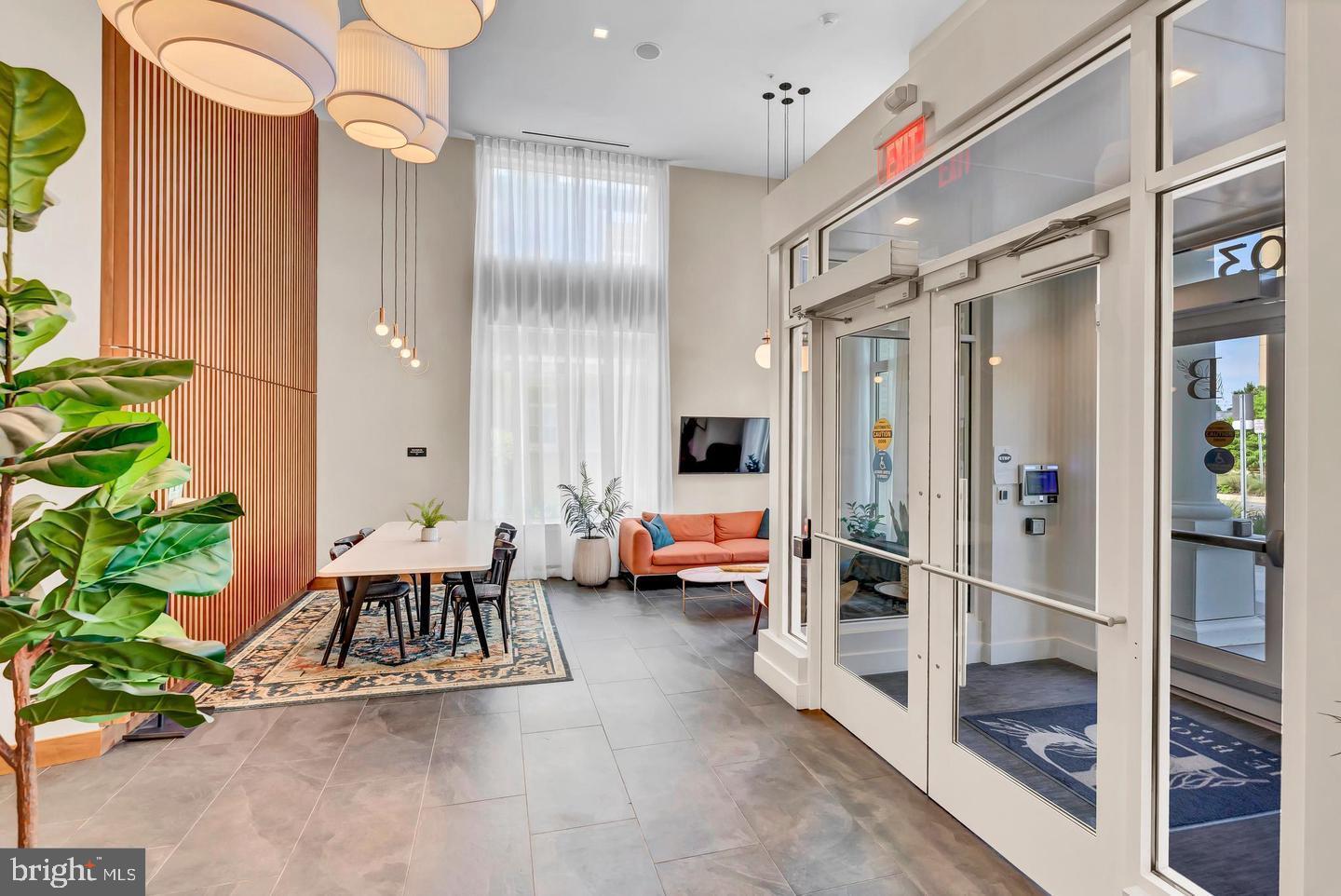 6803 Cameron Drive Northwest, Unit 514 Washington, DC 20012 - Photo 40 of 50 a view of living room filled with furniture and a potted plant