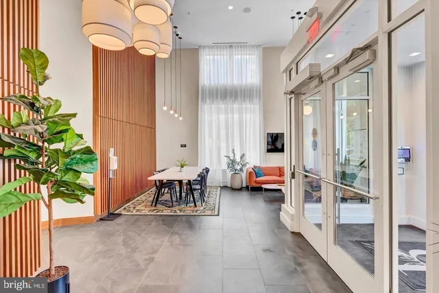 a dining room with furniture and a potted plant