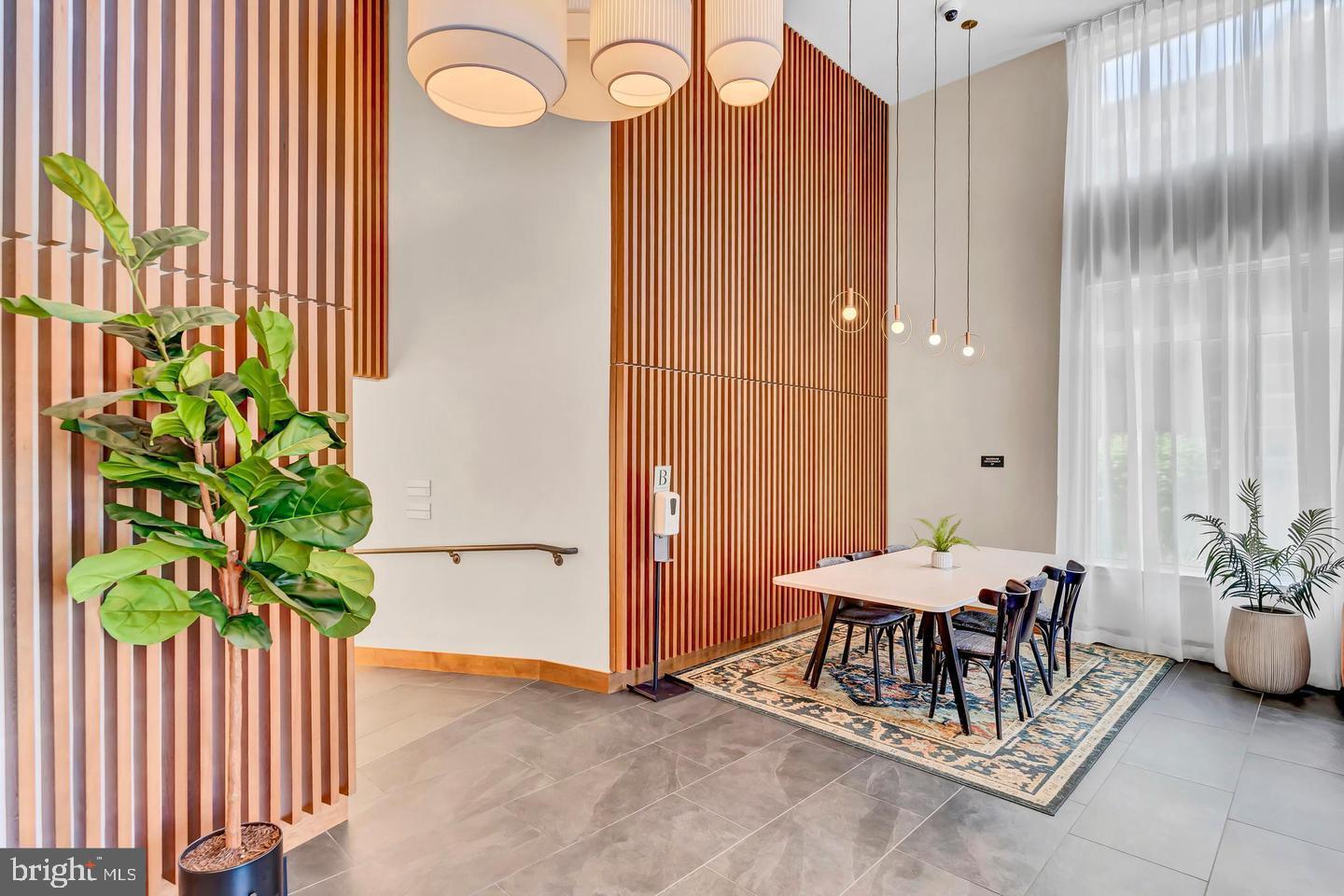 6803 Cameron Drive Northwest, Unit 514 Washington, DC 20012 - Photo 42 of 50 a dining room with furniture and a potted plant