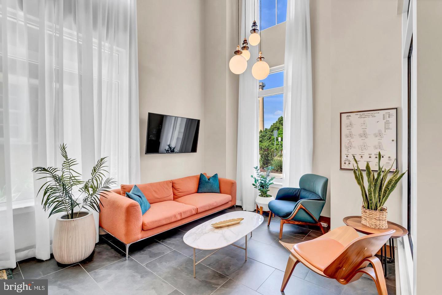 6803 Cameron Drive Northwest, Unit 514 Washington, DC 20012 - Photo 43 of 50 a living room with furniture and a flat screen tv