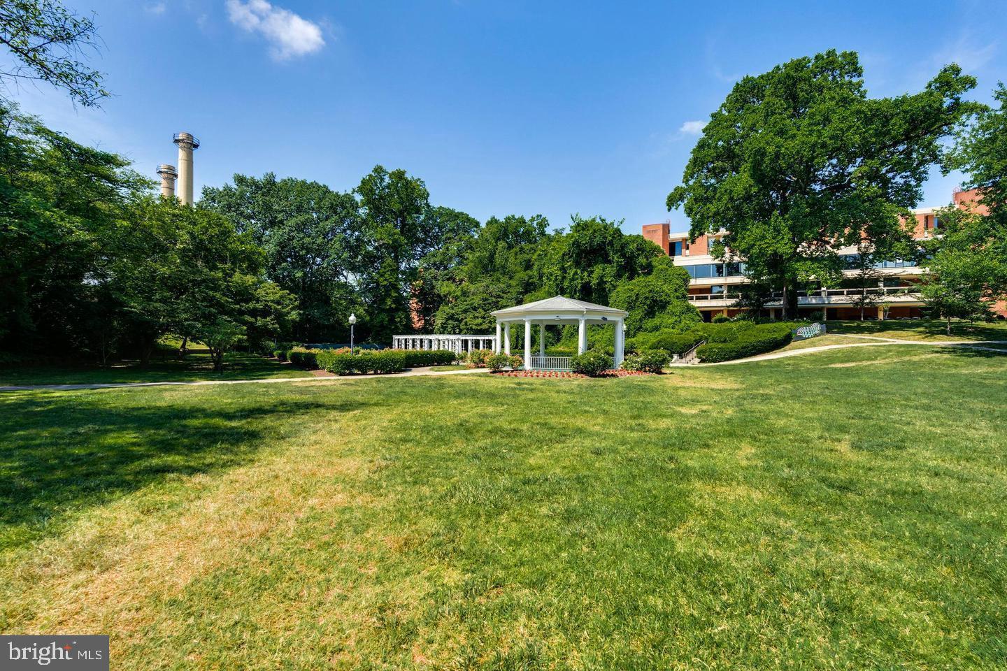 6803 Cameron Drive Northwest, Unit 514 Washington, DC 20012 - Photo 48 of 50 a view of a garden with a house in the background