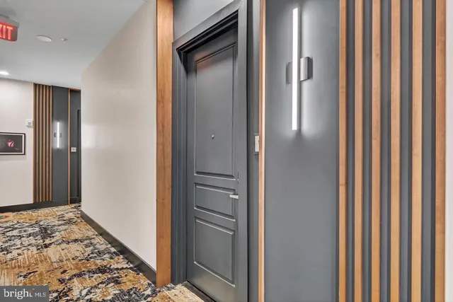 a kitchen with stainless steel appliances a stove a sink dishwasher a refrigerator white cabinets and wooden floor