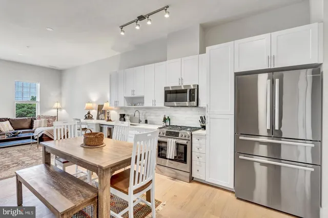 a kitchen with stainless steel appliances a refrigerator stove microwave and cabinets