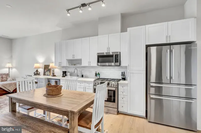 a kitchen with a refrigerator a microwave and cabinets