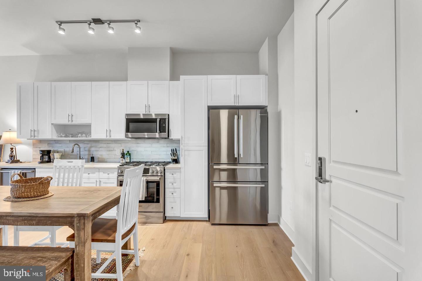 6803 Cameron Drive Northwest, Unit 514 Washington, DC 20012 - Photo 9 of 50 a kitchen with a refrigerator a microwave and cabinets