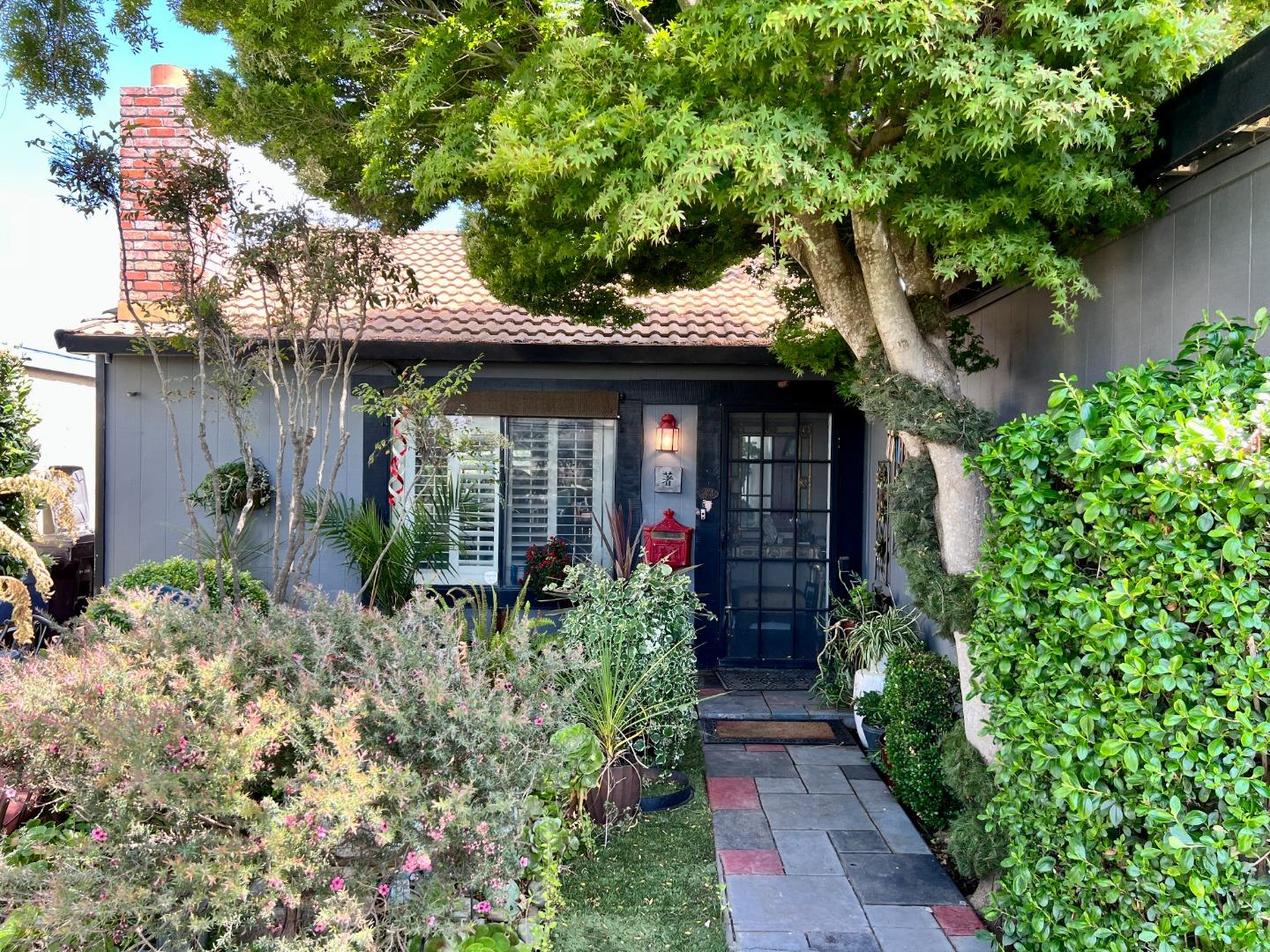 a view of a house with potted plants