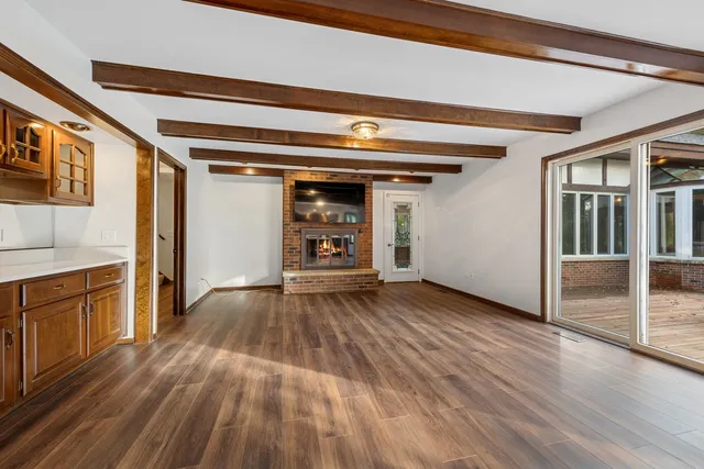 a view of a livingroom with furniture wooden floor and windows