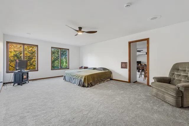 a spacious bathroom with a granite countertop sink mirror and a bathtub
